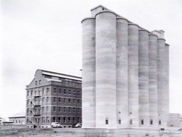 c 1940 depicting the south-west fa ade of the complex  including the 1926-7 storehouse and mill building  and the 1939 reinforced concrete silos