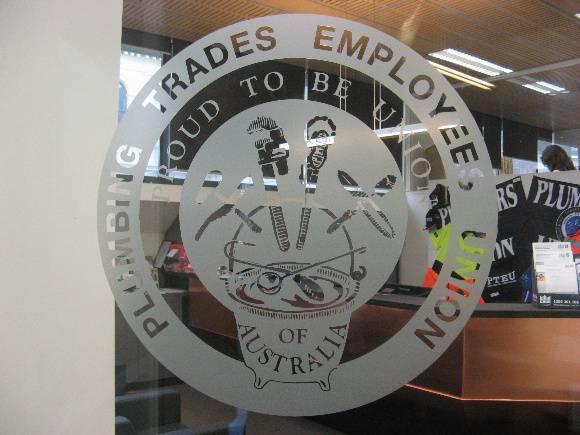 Plumbers & gasfitters etched glass doors on reception entrance
