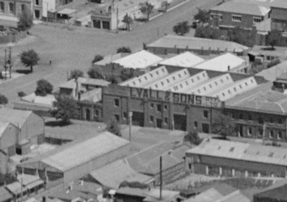 Fig 4. Corner site (Lots 1-2) (left), showing single storey masonry store on the Brougham Street frontage, rear two storey offices and modest skillion gabled outbuildings, 1938.  Also note the Lyalls and Sons produce store (right)( located on lots 3-6.