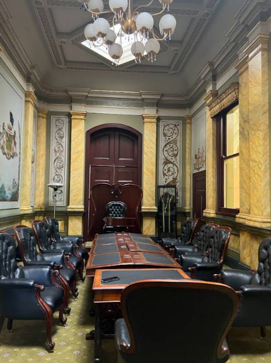 2023. Council Chamber (former) with furniture and wall paintings.