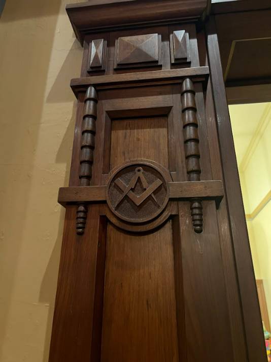2023. Masonic emblem to door frame.