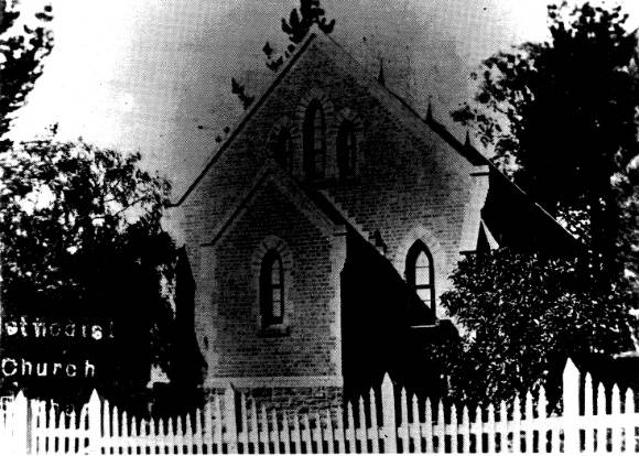 206 - Uniting Church Main Rd Eltham 02 - Old photograph of this church - note the timber picket fence and the site planting (ELHPC No. 646?) - Shire of Eltham Heritage Study 1992