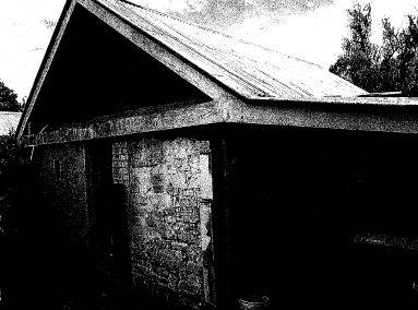 Detached store or early house from the south-east, showing shingle roof
under added gabled roof