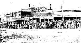 Former unicorn hotel - 1978
The Corner, Sturt Street, Ballarat, c.1866. The Unicorn Hotel can be seen to the centre left of the photograph, behind the brace of stockbrokers and their clients. The front brick facade can be seen clearly, before the erection of the main brick body of the building.
(photograph: H1790 LaTrobe Library)- Ballarat Conservation Study, 1978